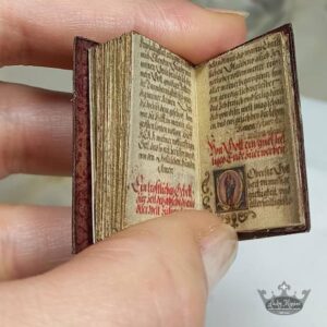 Miniature red book with small print on pages